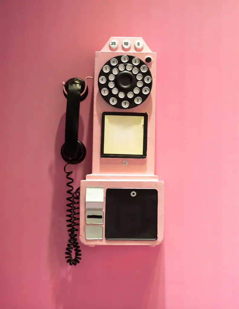 pink telephone on pink wall